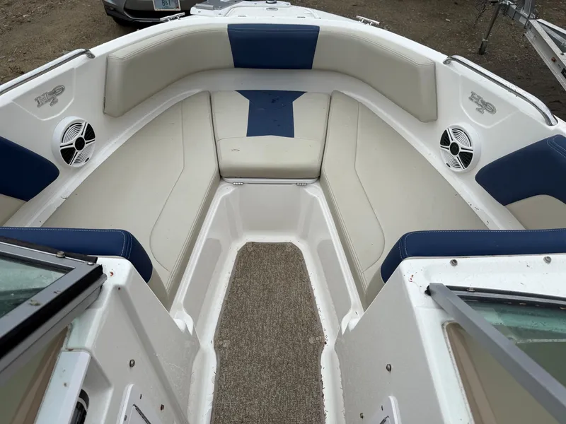 Slide: The Image of Interior of a 2014 Chaparral 210 boat with blue and white seating. - 5