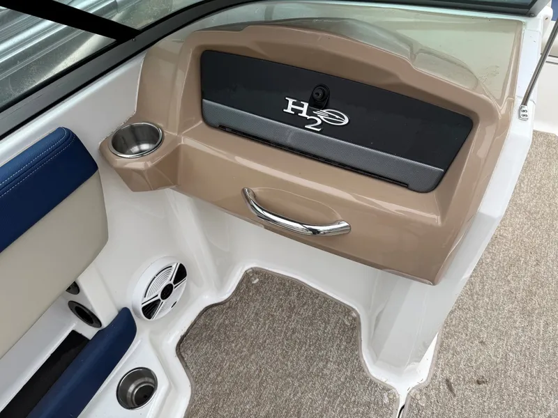 Slide: The Image of Interior of a 2014 Chaparral 210 boat with cup holder and speaker. - 7