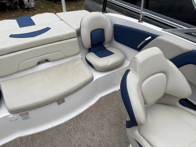 Slide: The Image of Interior of a 2014 Chaparral 210 boat with blue and white seating. - 9