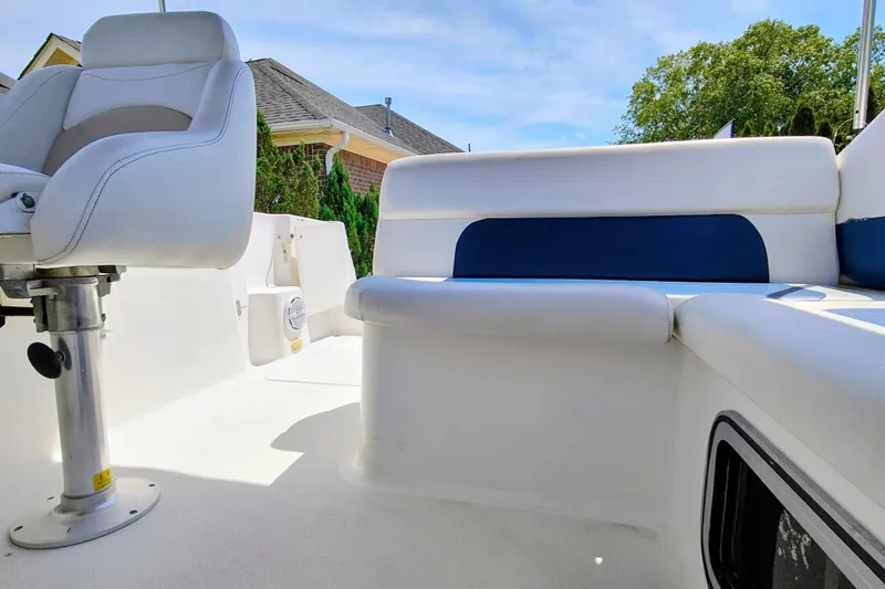 Slide: The Image of 2001 Glastron GS 249 boat interior with white seating and blue accents. - 14