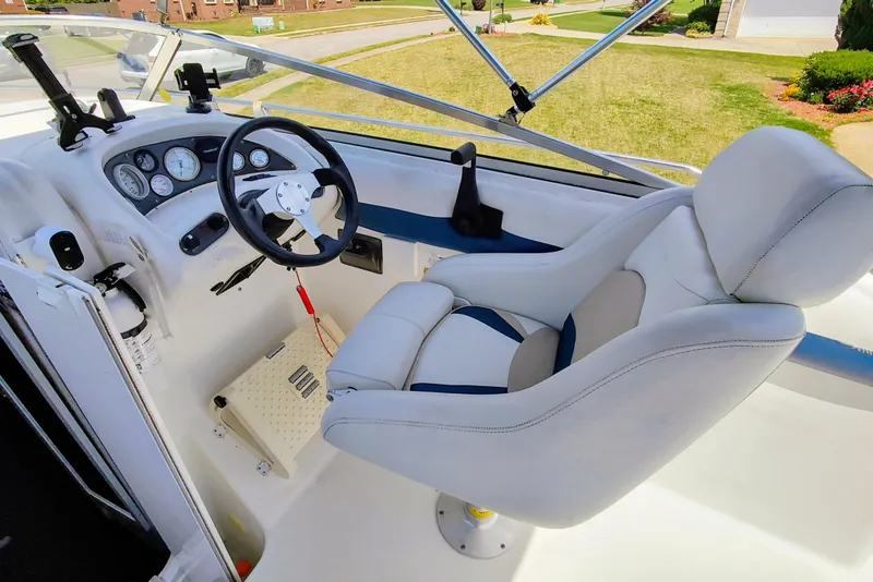Slide: The Image of 2001 Glastron GS 249 boat cockpit with steering wheel and comfortable seating. - 15