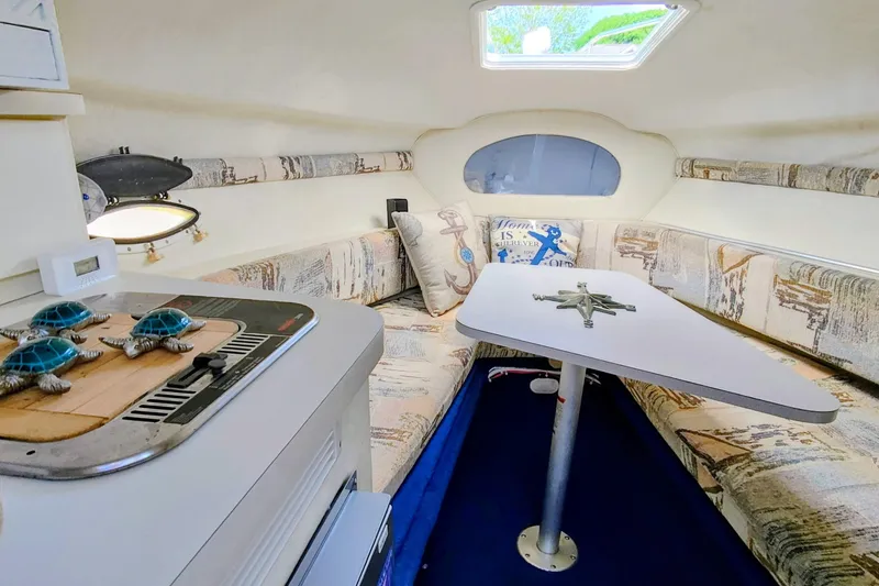 Slide: The Image of Interior of 2001 Glastron GS 249 boat with cozy seating and nautical decor. - 30