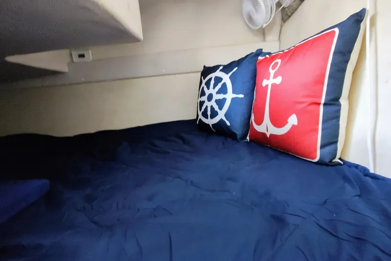Slide: The Image of Interior cabin of 2001 Glastron GS 249 with nautical-themed pillows. - 34