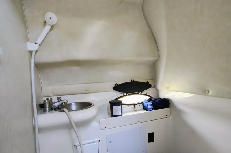 Slide: The Image of 2001 Glastron GS 249 boat interior with sink and showerhead. - 37
