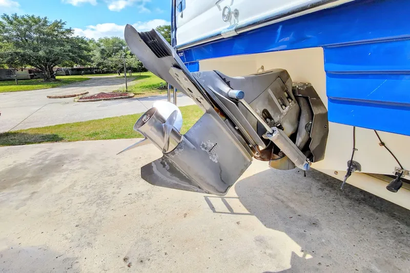 Slide: The Image of 2001 Glastron GS 249 boat propeller and stern drive, parked on concrete driveway. - 41