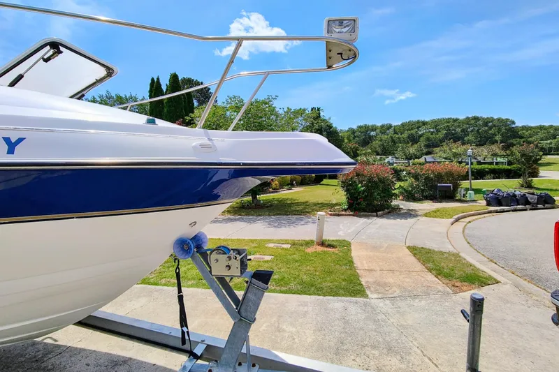 Slide: The Image of 2001 Glastron GS 249 boat on trailer in sunny suburban driveway. - 5
