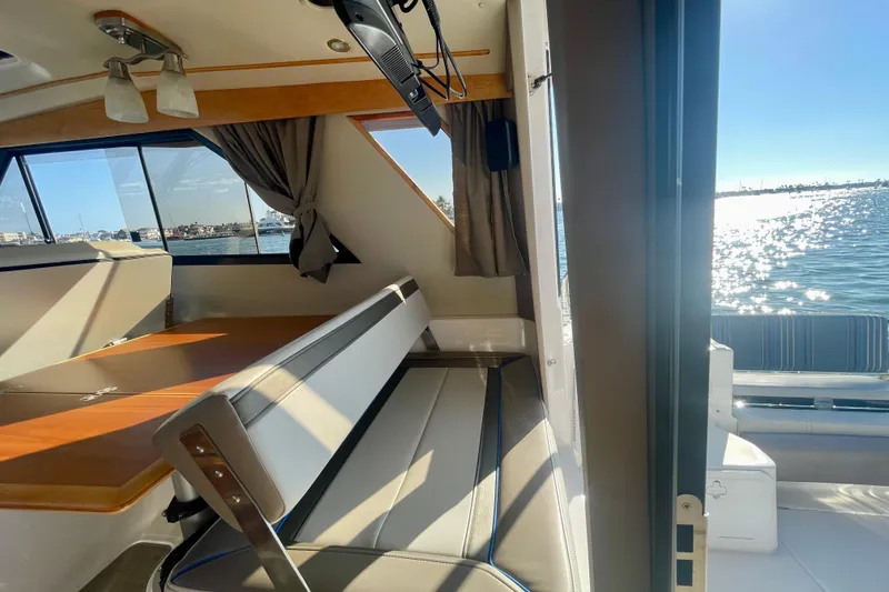Slide: The Image of Interior view of 2019 Cutwater C-302 Coupe boat with seating and ocean view. - 16