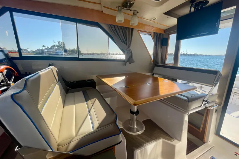 Slide: The Image of Interior of 2019 Cutwater C-302 Coupe with seating and table, overlooking water view. - 23