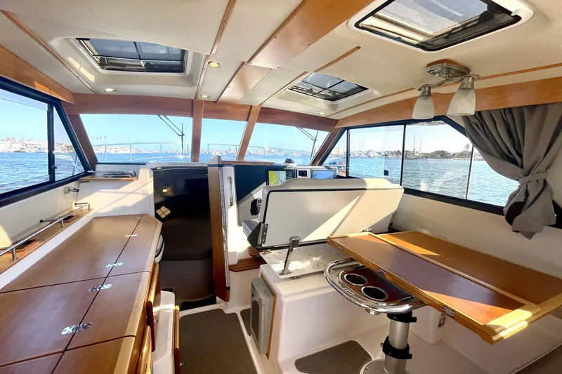 Slide: The Image of Interior of 2019 Cutwater C-302 Coupe boat with wood accents and water view. - 24