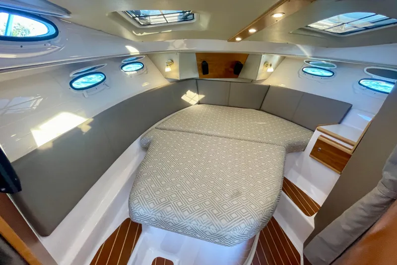 Slide: The Image of Interior of 2019 Cutwater C-302 Coupe, featuring a cozy cabin with elegant seating. - 26