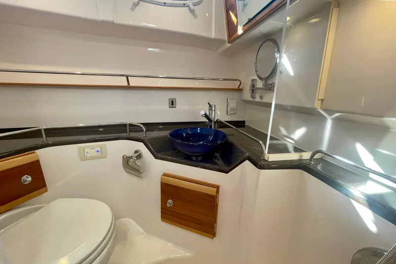 Slide: The Image of 2019 Cutwater C-302 Coupe bathroom with modern sink and wooden accents. - 27