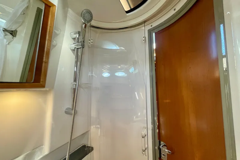 Slide: The Image of 2019 Cutwater C-302 Coupe bathroom with shower and wooden door. - 29