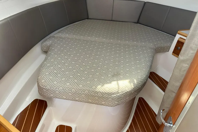 Slide: The Image of 2019 Cutwater C-302 Coupe interior cabin with patterned bedding and wooden flooring. - 9