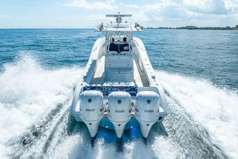 Slide: The Image of 2020 Yellowfin 36 Offshore boat on the sea with three outboard engines. - 11