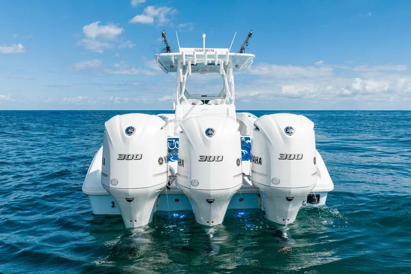 Slide: The Image of 2020 Yellowfin 36 Offshore with triple Yamaha engines on open sea. - 14