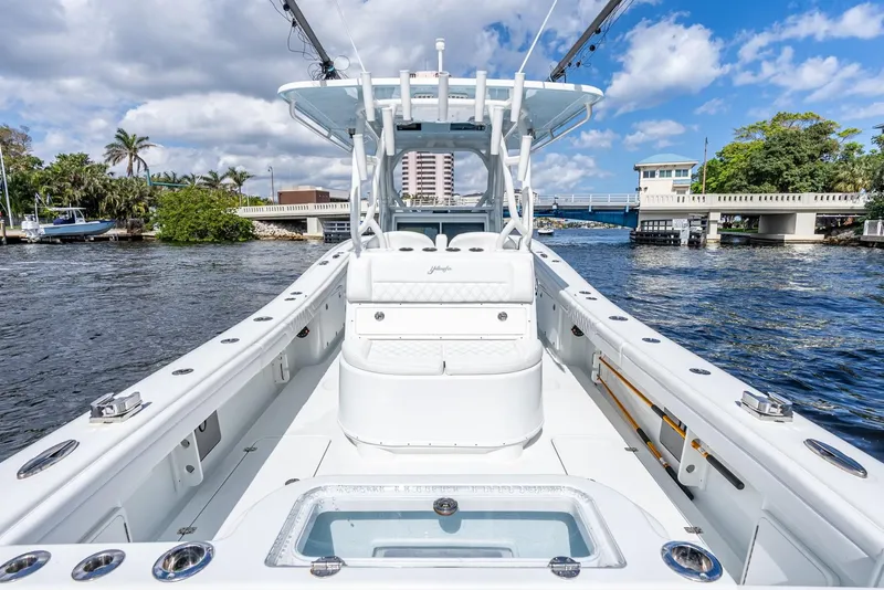Slide: The Image of 2020 Yellowfin 36 Offshore boat on water with bridge in background. - 20