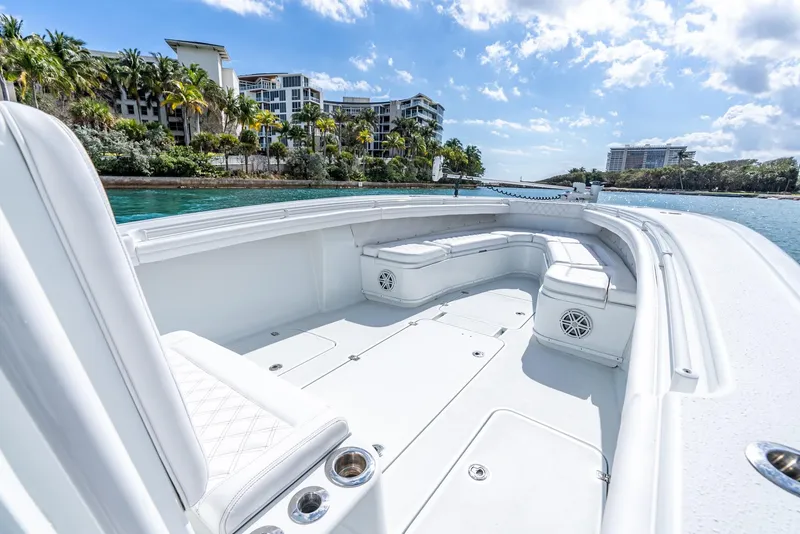 Slide: The Image of 2020 Yellowfin 36 Offshore boat on calm waters near coastal buildings. - 29