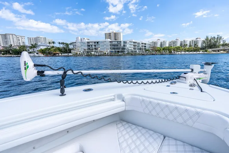 Slide: The Image of 2020 Yellowfin 36 Offshore boat on calm water with cityscape view. - 38