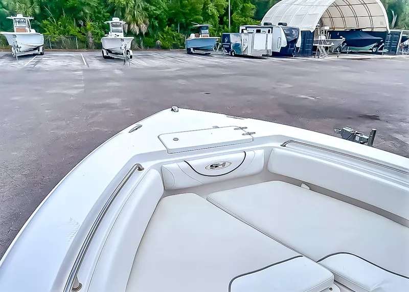 Slide: The Image of 2014 Sea Hunt Ultra 235 boat parked in a lot. - 12