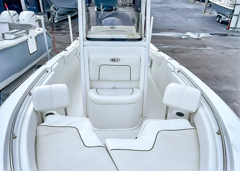 Slide: The Image of Interior of a 2014 Sea Hunt Ultra 235 boat with white seating. - 13