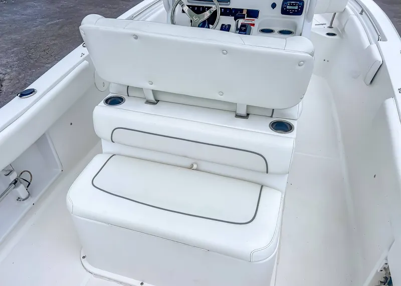 Slide: The Image of Interior of a 2014 Sea Hunt Ultra 235 boat with white seating. - 8