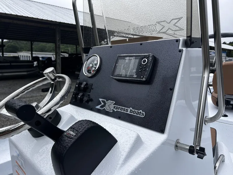 Slide: The Image of 2026 Xpress H20B Bay boat console with controls and instruments. - 7