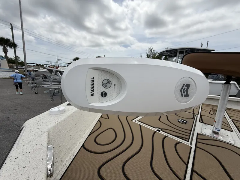 Slide: The Image of Xpress X23B Bay Lounge 2026 with Terrova motor on boat deck. - 13
