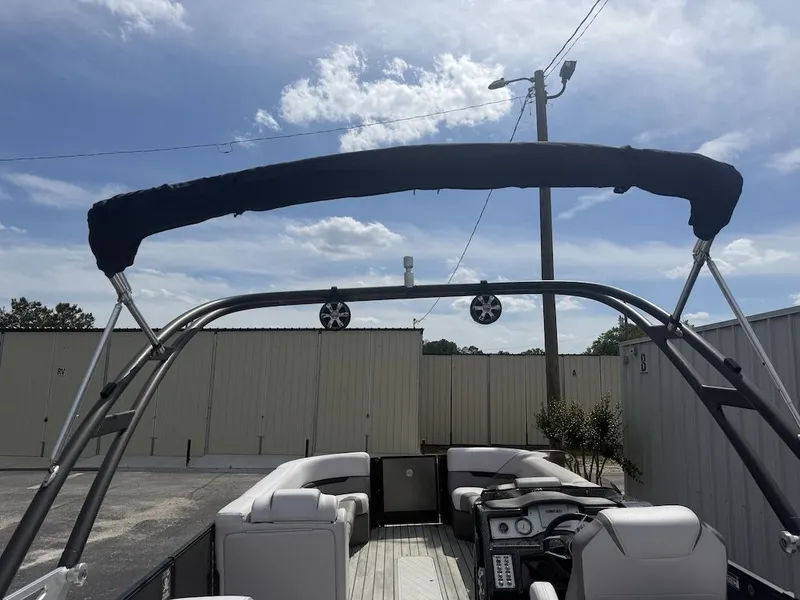 Slide: The Image of 2017 Crest Caliber 250 SLR2 pontoon boat with Bimini top and speakers. - 21
