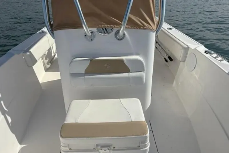Slide: The Image of 2018 Edgewater 188CC boat interior with seating and console on water. - 11