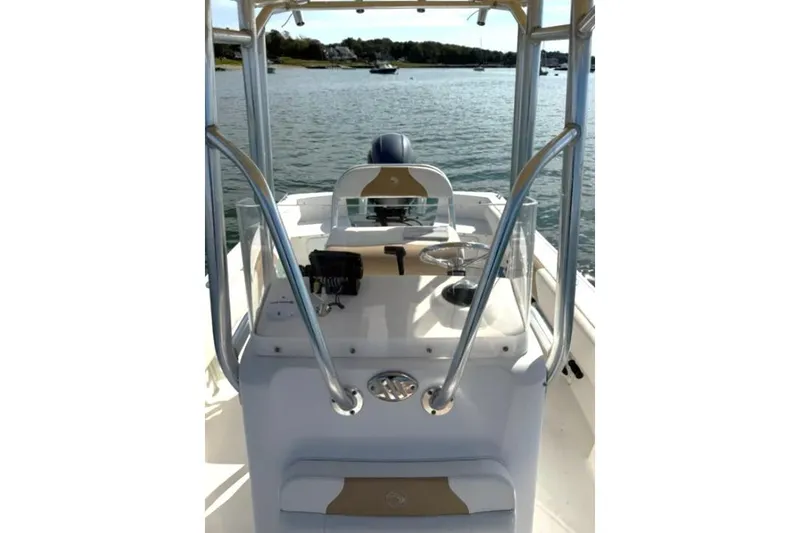 Slide: The Image of 2018 Edgewater 188CC boat console with steering wheel on calm water. - 13