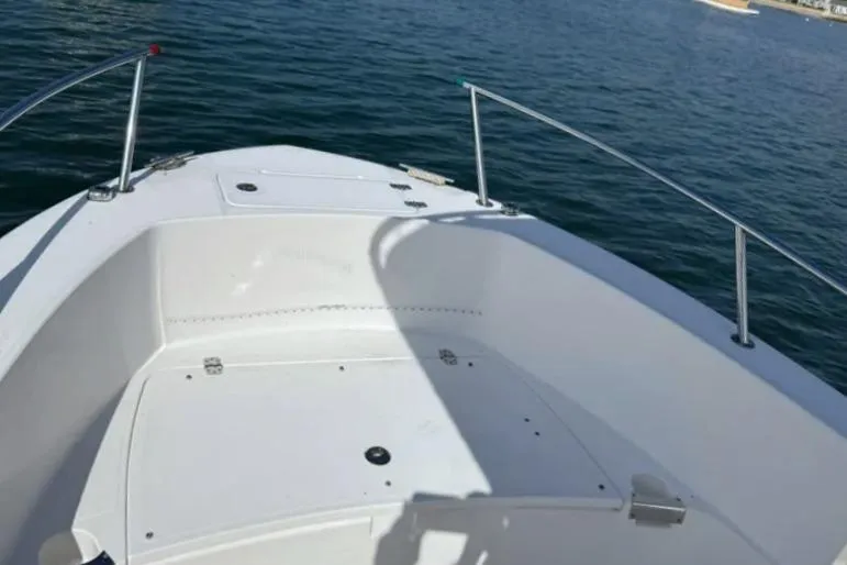 Slide: The Image of 2018 Edgewater 188CC boat bow on calm water, showcasing sleek design and spacious deck. - 15