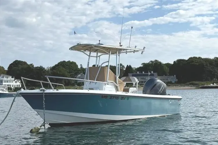 Slide: The Image of 2018 Edgewater 188CC boat anchored on calm water under a partly cloudy sky. - 2