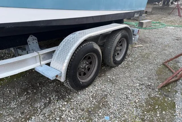 Slide: The Image of Trailer for 2018 Edgewater 188CC boat on gravel surface. - 20