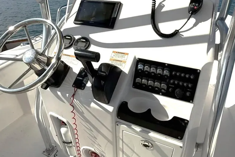 Slide: The Image of Control panel of a 2018 Edgewater 188CC boat with steering wheel and gauges. - 4