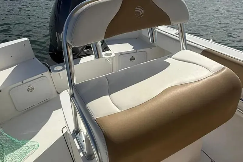 Slide: The Image of 2018 Edgewater 188CC boat interior with cushioned seating and storage compartments. - 9