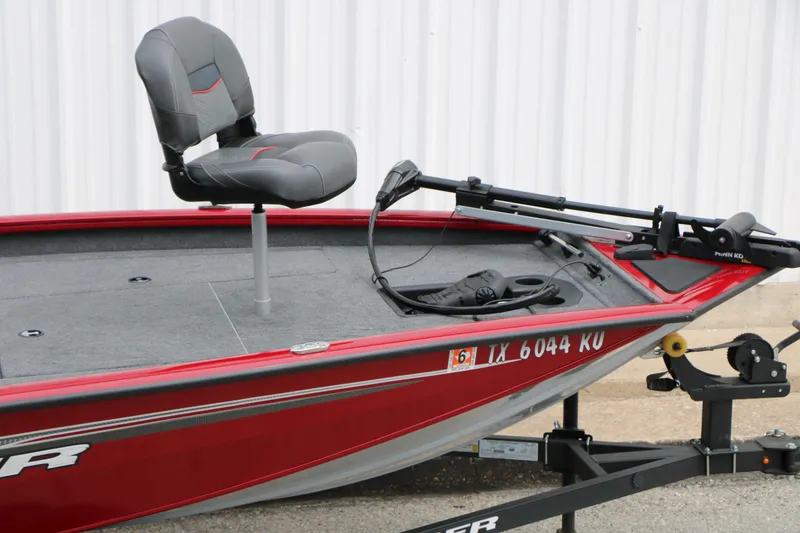 Slide: The Image of 2024 Tracker Pro Team 175 boat, red exterior, with a mounted seat and trolling motor. - 10