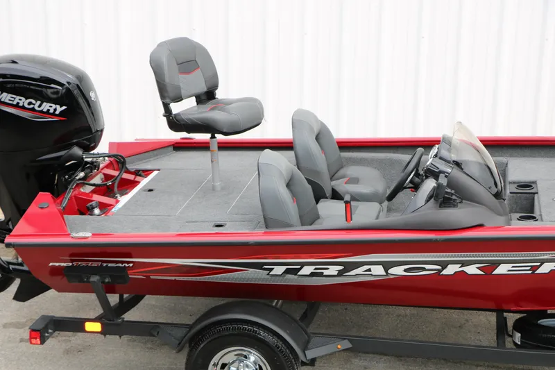 Slide: The Image of 2024 Tracker Pro Team 175 boat with Mercury engine, red exterior, and gray seating. - 11