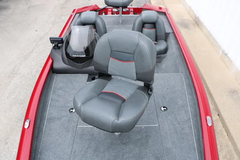 Slide: The Image of 2024 Tracker Pro Team 175 boat interior with gray seats and red accents. - 18