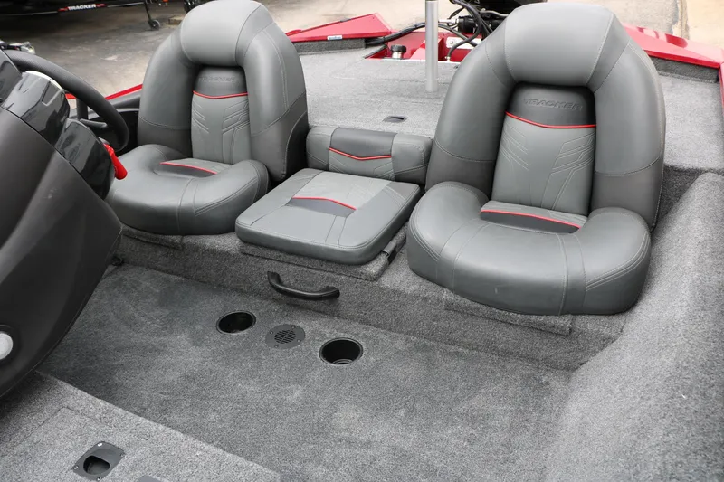 Slide: The Image of 2024 Tracker Pro Team 175 boat interior with gray seating and red accents. - 23