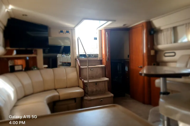 Slide: The Image of Interior of 2000 Sea Ray 420 Aft Cabin yacht with plush seating and stairs. - 15