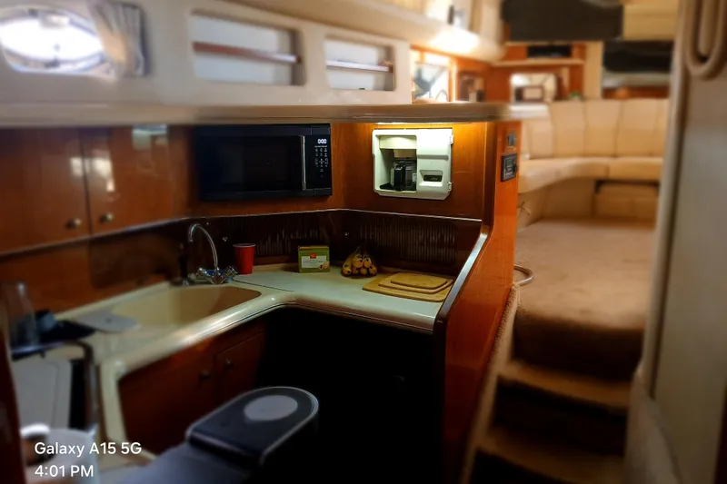 Slide: The Image of Interior of 2000 Sea Ray 420 Aft Cabin yacht with kitchen and seating area. - 18
