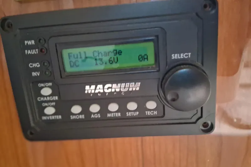 Slide: The Image of Magnum Energy control panel displaying full charge at 13.6V on Sea Ray 420 Aft Cabin. - 25
