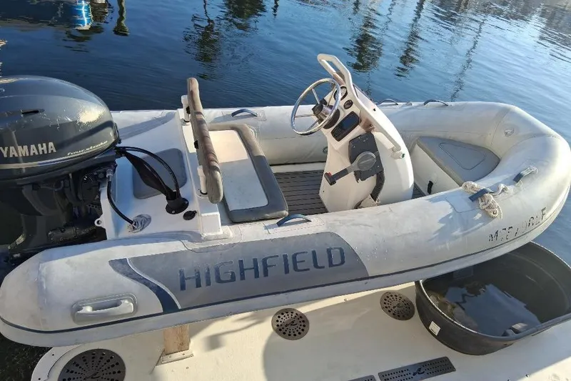 Slide: The Image of Inflatable Highfield boat with Yamaha motor, docked on water. - 5