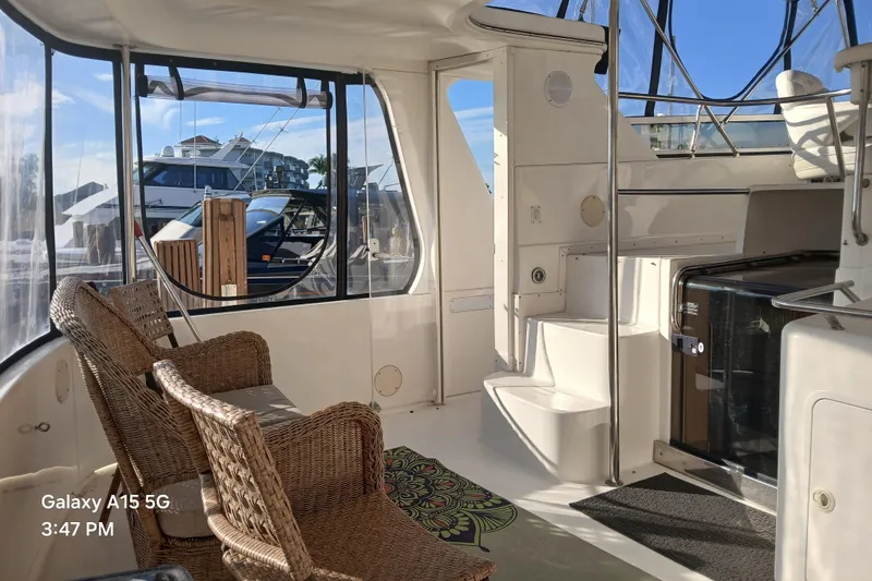 Slide: The Image of Interior of 2000 Sea Ray 420 Aft Cabin yacht with wicker chairs and stairs. - 6