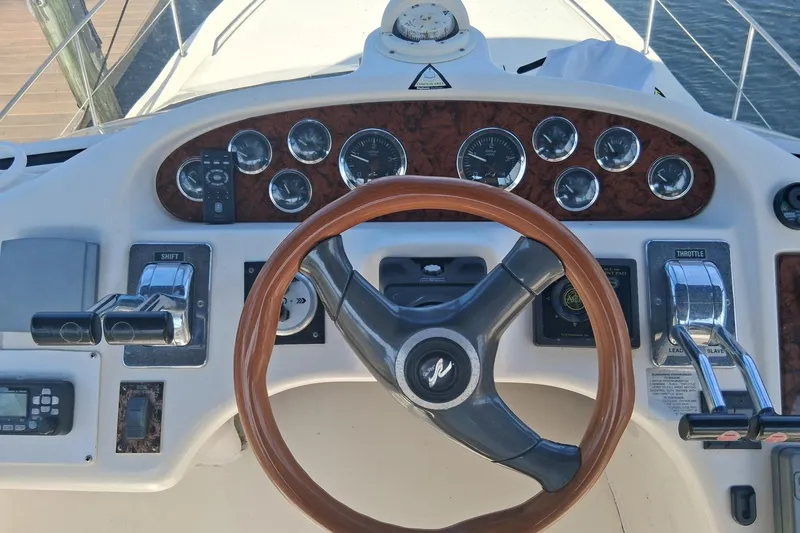 Slide: The Image of Helm of 2000 Sea Ray 420 Aft Cabin yacht with gauges and controls. - 21