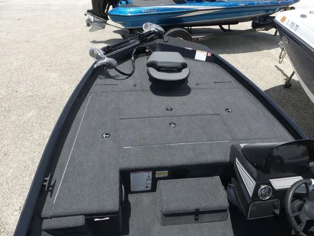 Slide: The Image of 2026 Lowe Stinger 175C boat interior with gray carpet. - 11