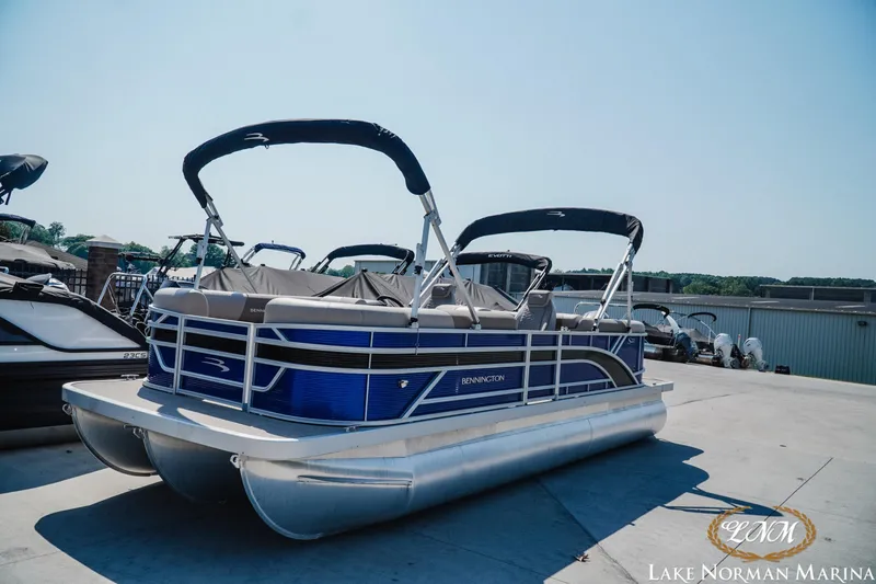 The Image of 2024 Bennington 22SSR-SPS pontoon boat at Lake Norman Marina, featuring sleek design and blue accents. - 1