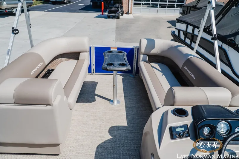 Slide: The Image of 2024 Bennington 22SSR-SPS pontoon boat interior with beige seating and central table. - 11