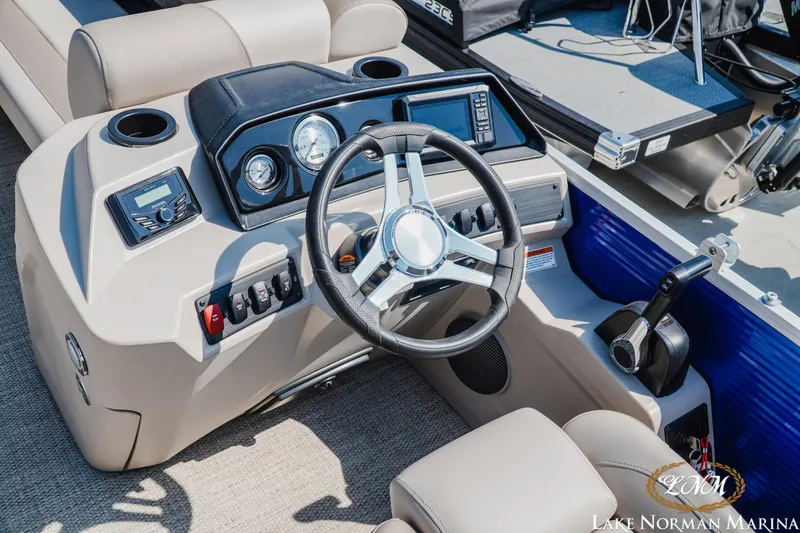 Slide: The Image of 2024 Bennington 22SSR-SPS boat dashboard with steering wheel and control panel. - 12