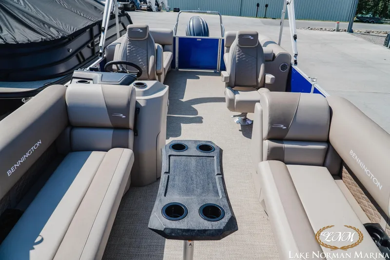 Slide: The Image of 2024 Bennington 22SSR-SPS pontoon boat interior with beige seating and central table. - 14